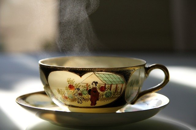 A profile picture of a decorative china cup with an oriental motif.  Colours dark brown and greens with a picture of two oriental figures working in a garden. There is steam coming from the cup.  The intention of the picture is to demonstrate the power of having a cup of tea and that the best hypnotherapy comes in a cup.