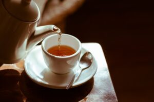 A picture of tea being poured into a china cup from a tea pot. It represents the time when we can relax and let go of tension. It is linked to the idea that the best hypnotherapy can be found in a cup of tea