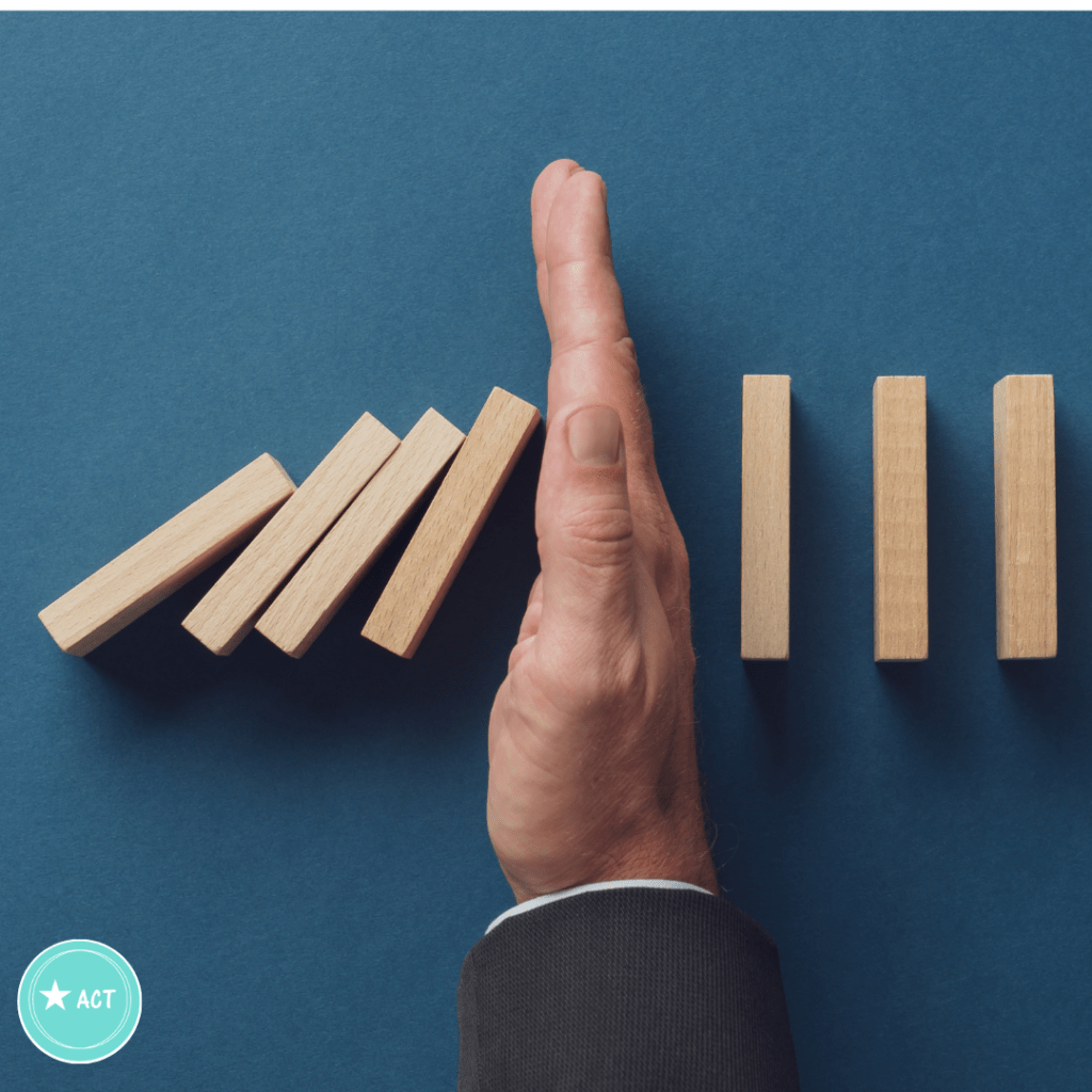 This a picture of 8 wooden rectangular blocks lined up on their short eds in a row.  They look as if they are going to tumble down. The first four have, but the remaining are prevented from falling down by a hand. The purpose of the picture is to convey that habits can be stopped by intervention. The same is true with Gratitude habit building the first step is to take back control and by stopping the old unhelpful behaviours. Gratitude Habit building.