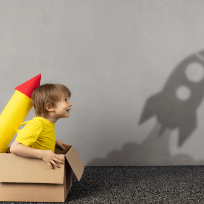 Boy with yellow rocket and shadow A picture of a little boy in a yellow T-shirt sat in a cardboard box with a make make shift yellow and red rocket positioned on his back. On the wall to the side of him is a shadow of a rocket blasting off. The image is there to symbolise the imagination and how EFT and the Emotional Freedom Technique can make a difference.